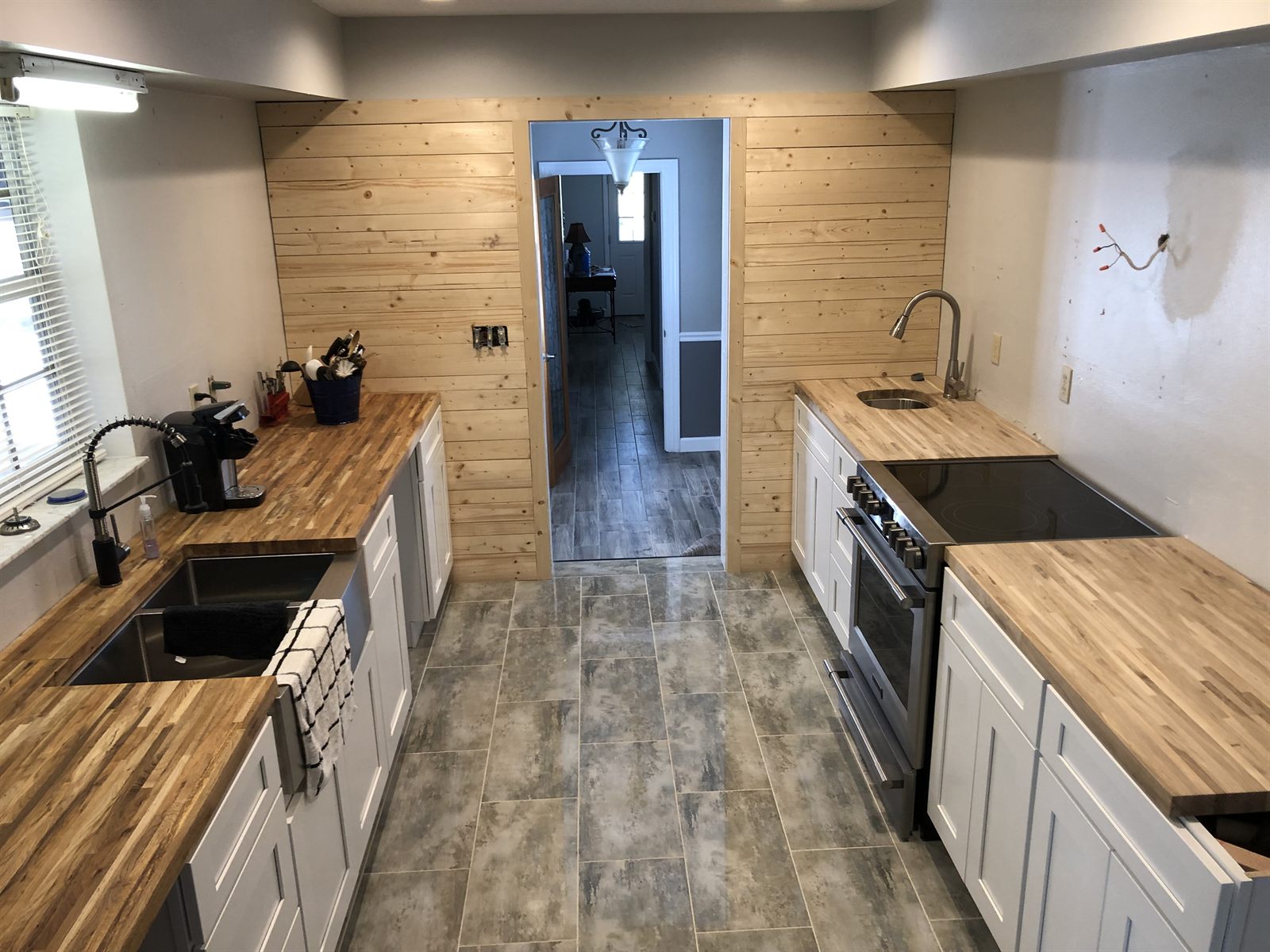 Kitchen with butcher-block counters and shiplap wall